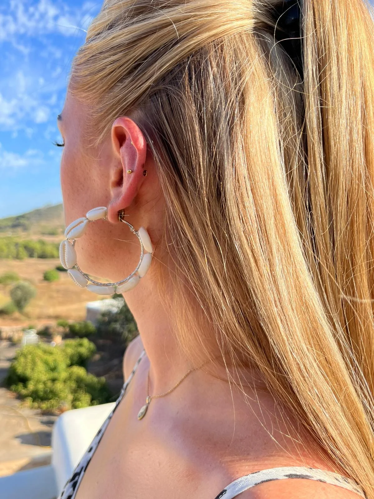Shell hoop earrings worn by model